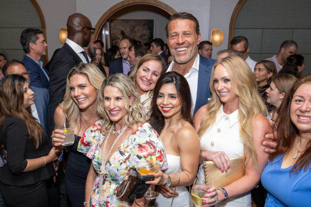 Fountain Life co-founder Tony Robbins is surrounded by adoring femmes during the Houston opening of Fountain Life on the first floor of Park House (Photo by Jacob Power)