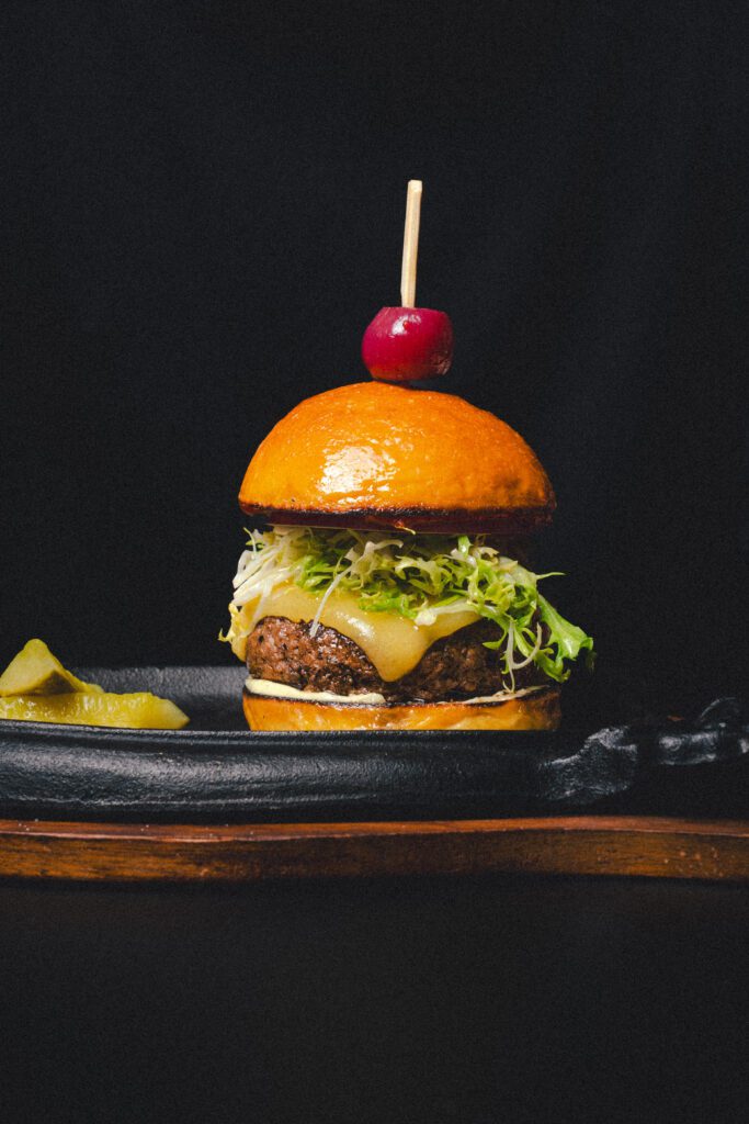 The all-American Toga burger ($25) is a mixture of ground Wagyu brisket and beef heart served on a potato bun with Comté, tomato marmalade and red onion. 