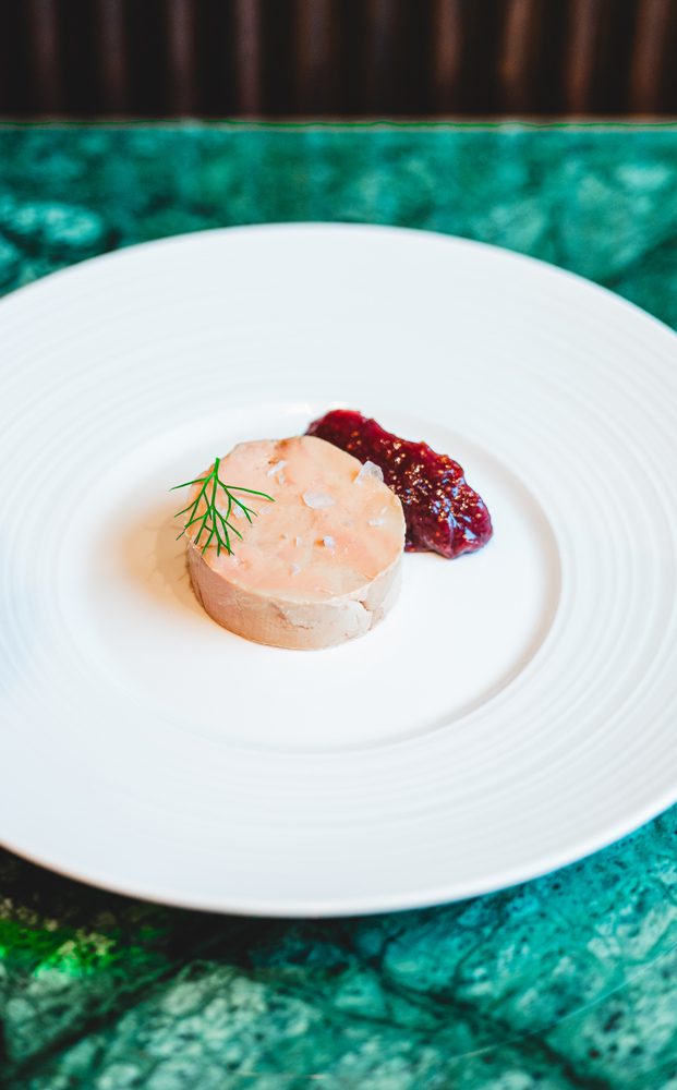 Foie gras torchon atop crostini with a fig preserve is an Osteria di Mercato.