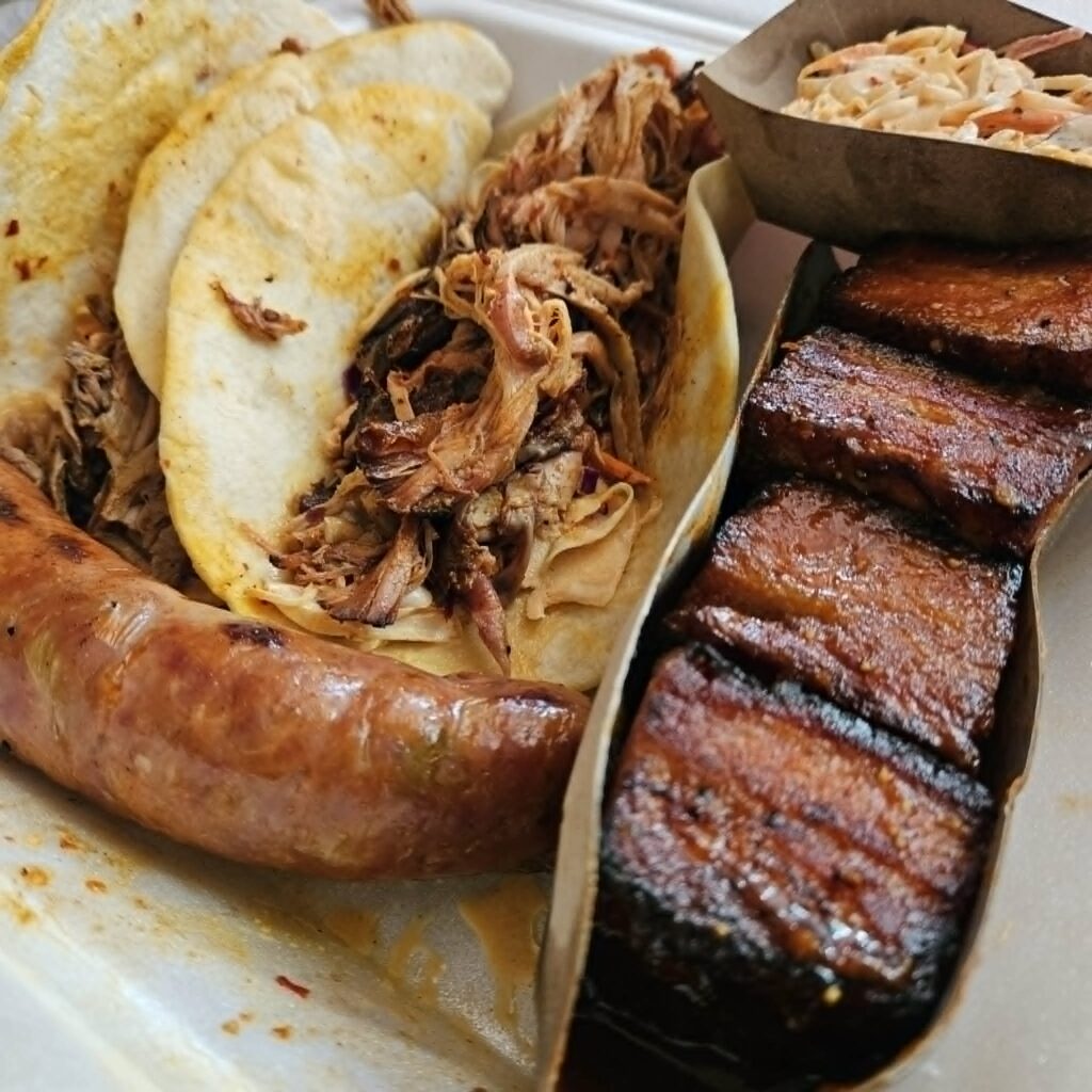 Ross and Katherine Marquette, co-owners of Smoke and Bone BBQ, bring their own enjoyable take on the statewide tradition with Dr. Pepper-glazed pork belly burnt ends, sriracha sausage links, tacos, ramen, and traditional ribs, brisket, and pulled pork.  (Courtesy)

