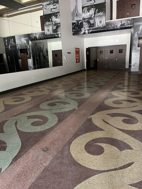 Botanical flourishes bloom across the terrazzo lobby floor in Garden Oaks Theater.