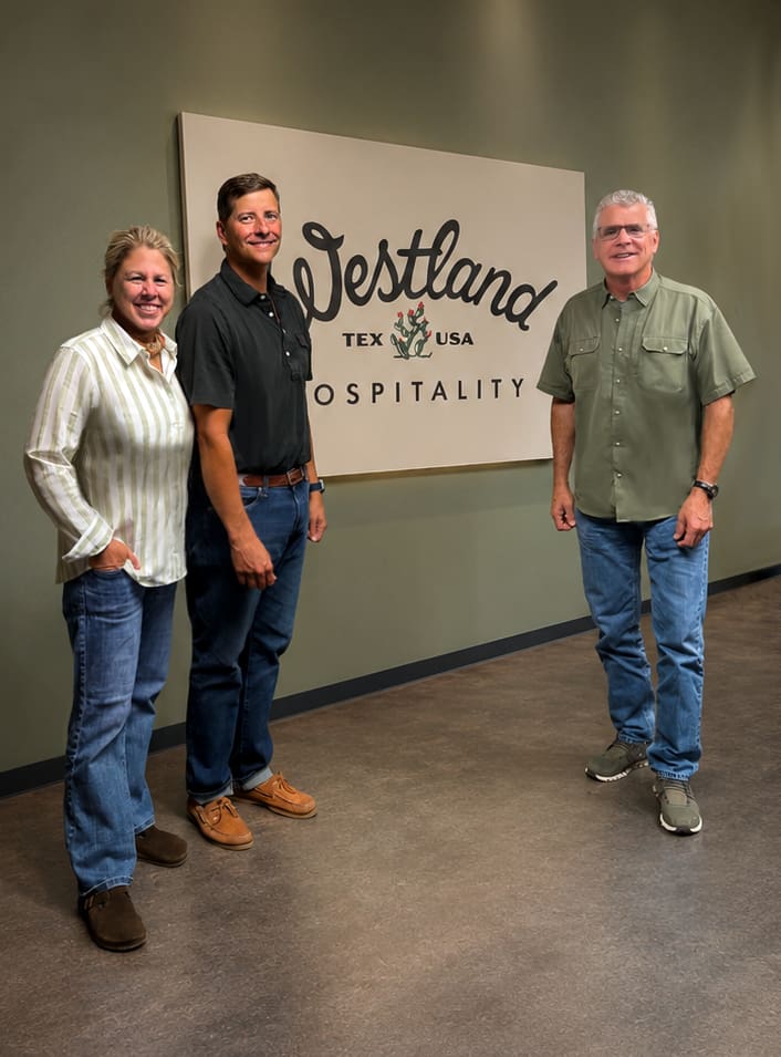 From left: Gigi Howell, Mark Harris and Bourke Harvey are pictured at Westland Hospitality’s office. (Courtesy) 