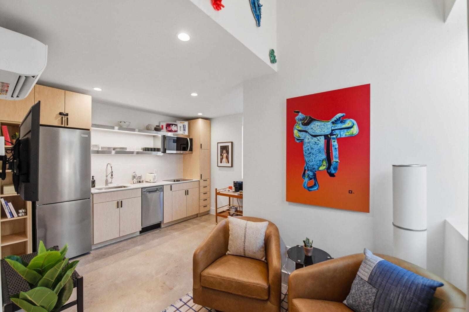 Inside a Hotel SOMA casita, soaring ceilings, full kitchens, cozy seating areas, and artwork sourced through William Campbell Contemporary create a stay that feels more like a stylish tiny home than a traditional hotel room. (Courtesy)