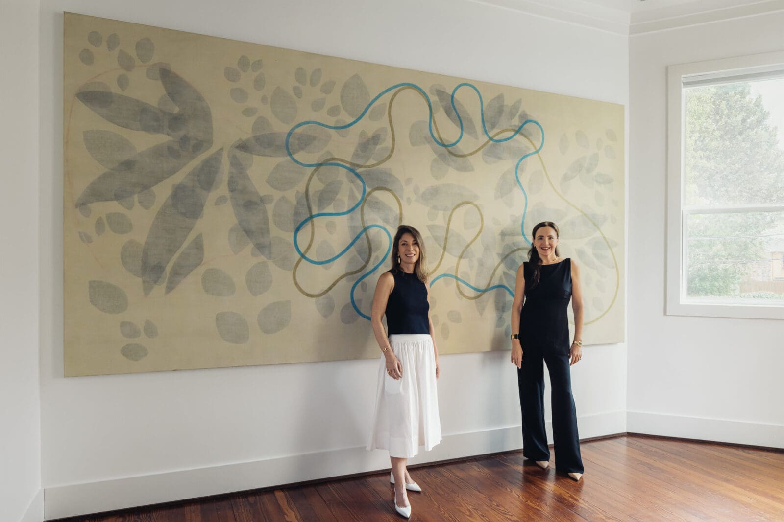 PAC Art founder Paola Creixell (right) with curator Simone Coscarell, founder Plural Arte y Cultura. Artwork Alejandro Corjueria. The pair are shown in PAC Art House's "Poetics of Matter," public opening Saturday, October 3, 11 am. (Photo Francisco Ramos)