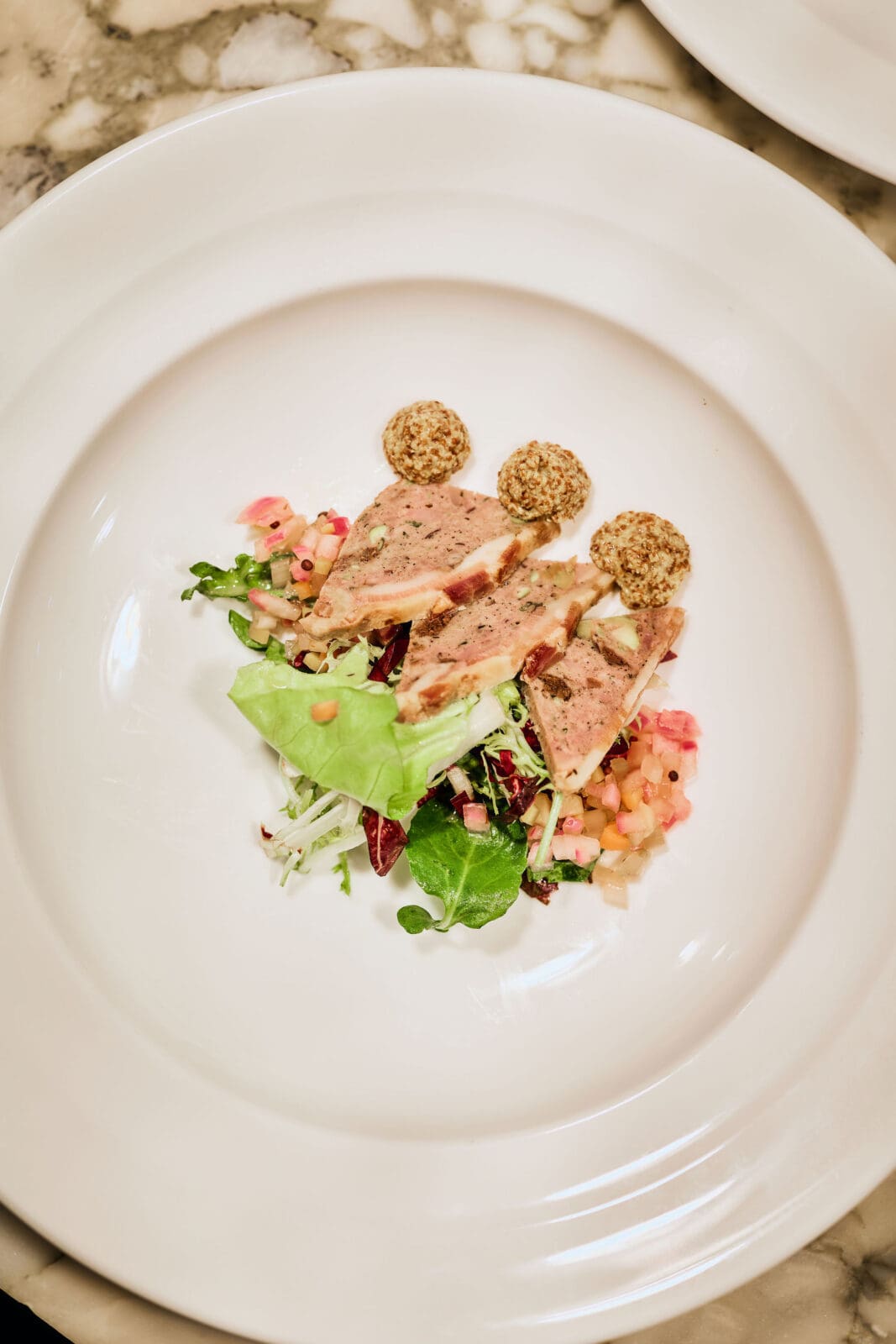 The four-course dinner, which included over ninety guests in attendance, featured dishes by CBD Provisions Chef Sezer Deniz and guest chefs Michael ‘Batman’ Rhodes of Café Momentum and Eduardo Osorio of Meridian. (Photo by Chase Hall )