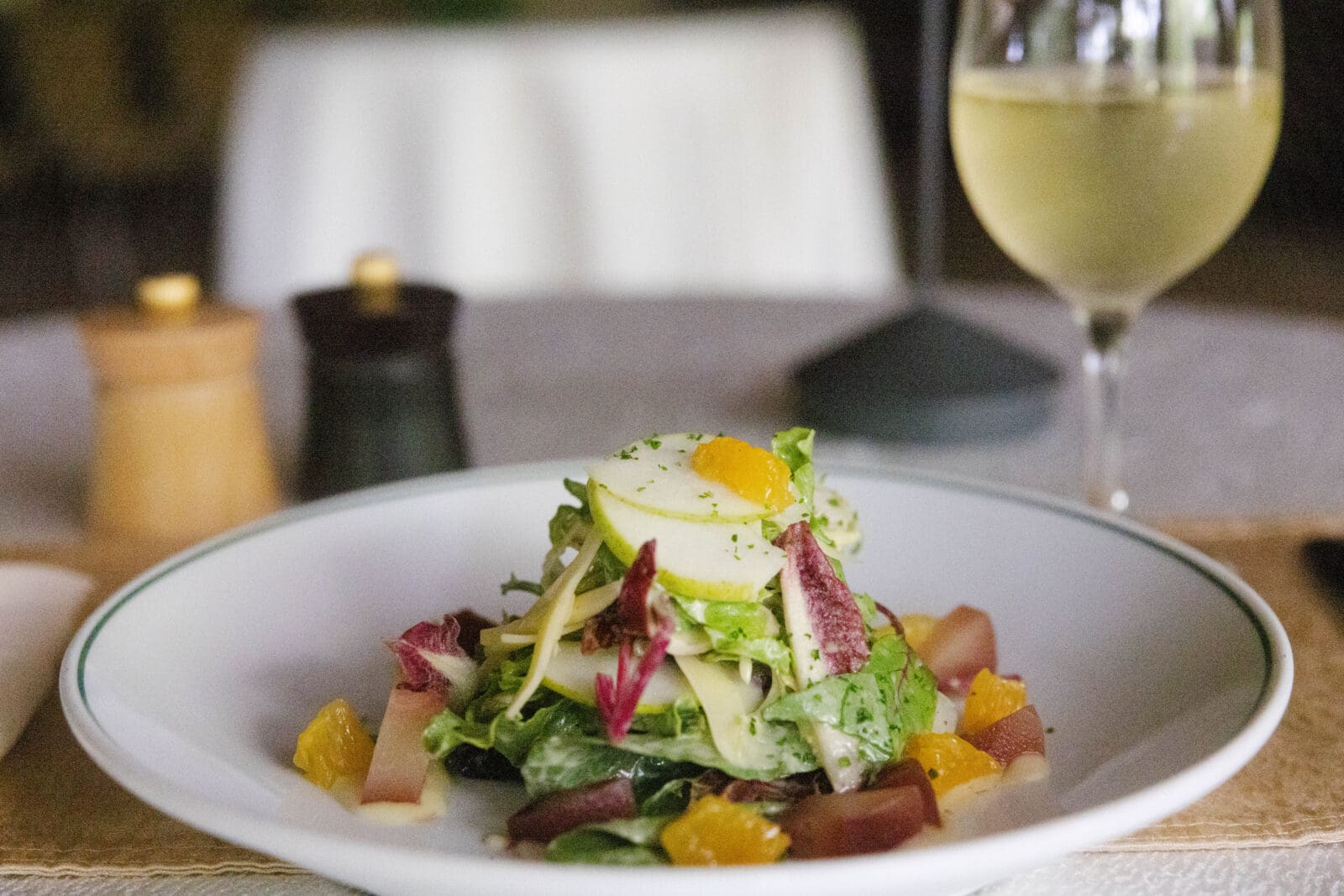 The Central Texas Orchard Salad features local greens, Hill Country pear, and Veldhuizen Gouda, highlighting the flavors and craftsmanship that define Texas farm-to-table cuisine. 