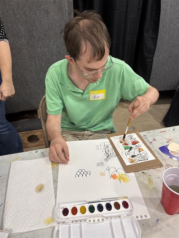 An artist and his sketchbook, working with Woodlands Arts League guidance. (Photo courtesy of Project Beacon)