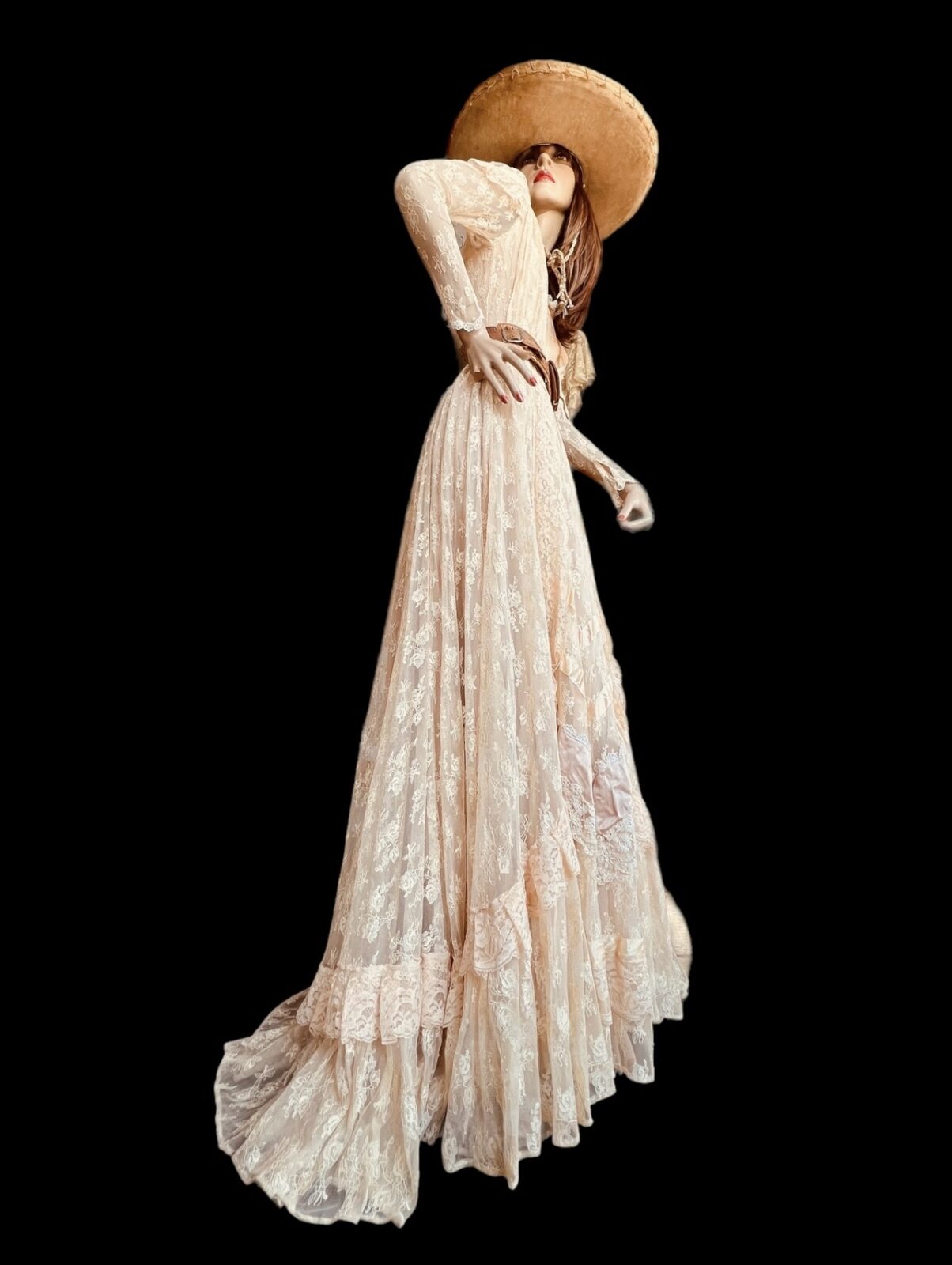 A flowing lace gown and oversized cowboy hat bring a dramatic Western flair to Studio 74 Vintage’s collection. (Photo by Studio 74 Vintage)