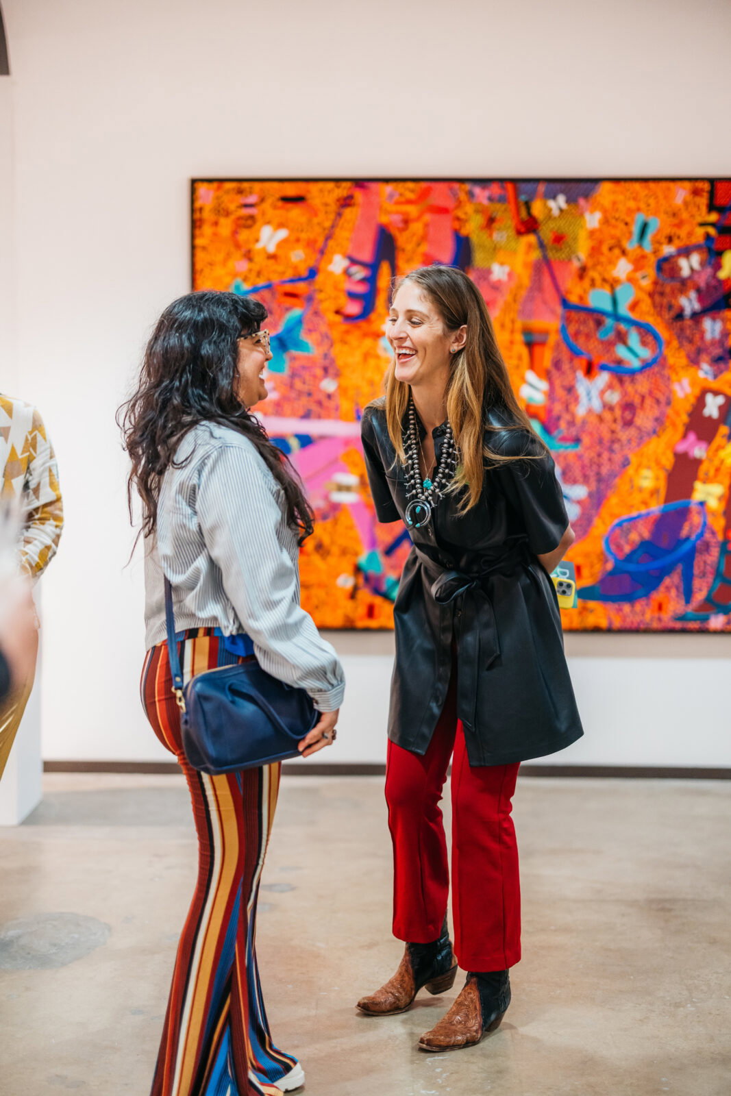 Kelly Cornell converses with a fair visitor. The Dallas Art Fair director was a catalyst in the move to her alma mater, SMU. (Photo courtesy of Dallas Art Fair)