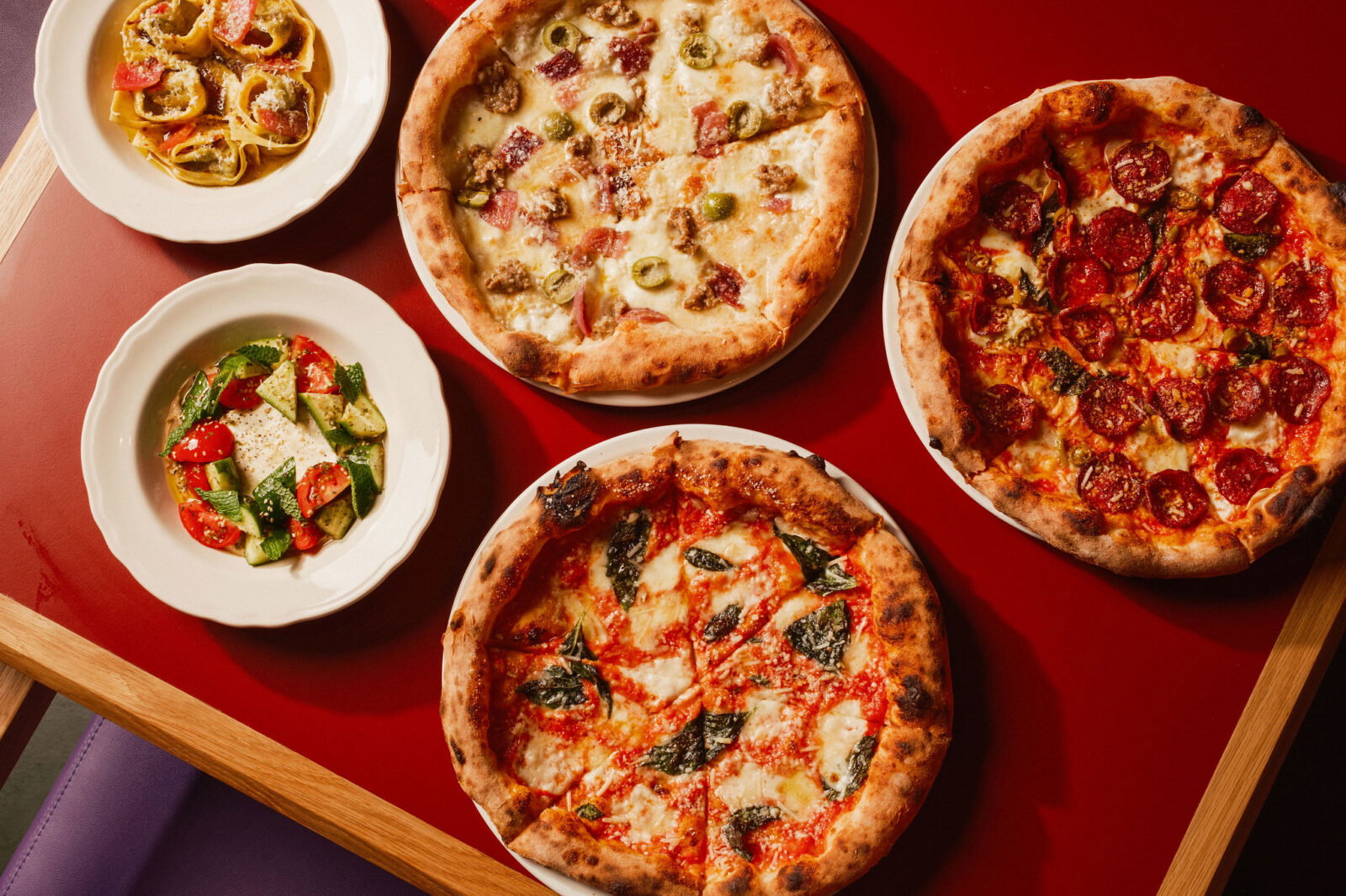 An array of the wood-fired Neapolitan pizzas and dishes served at the new Angie's PIzza in The Heights. (Photo by Chris Quit Nguyen)