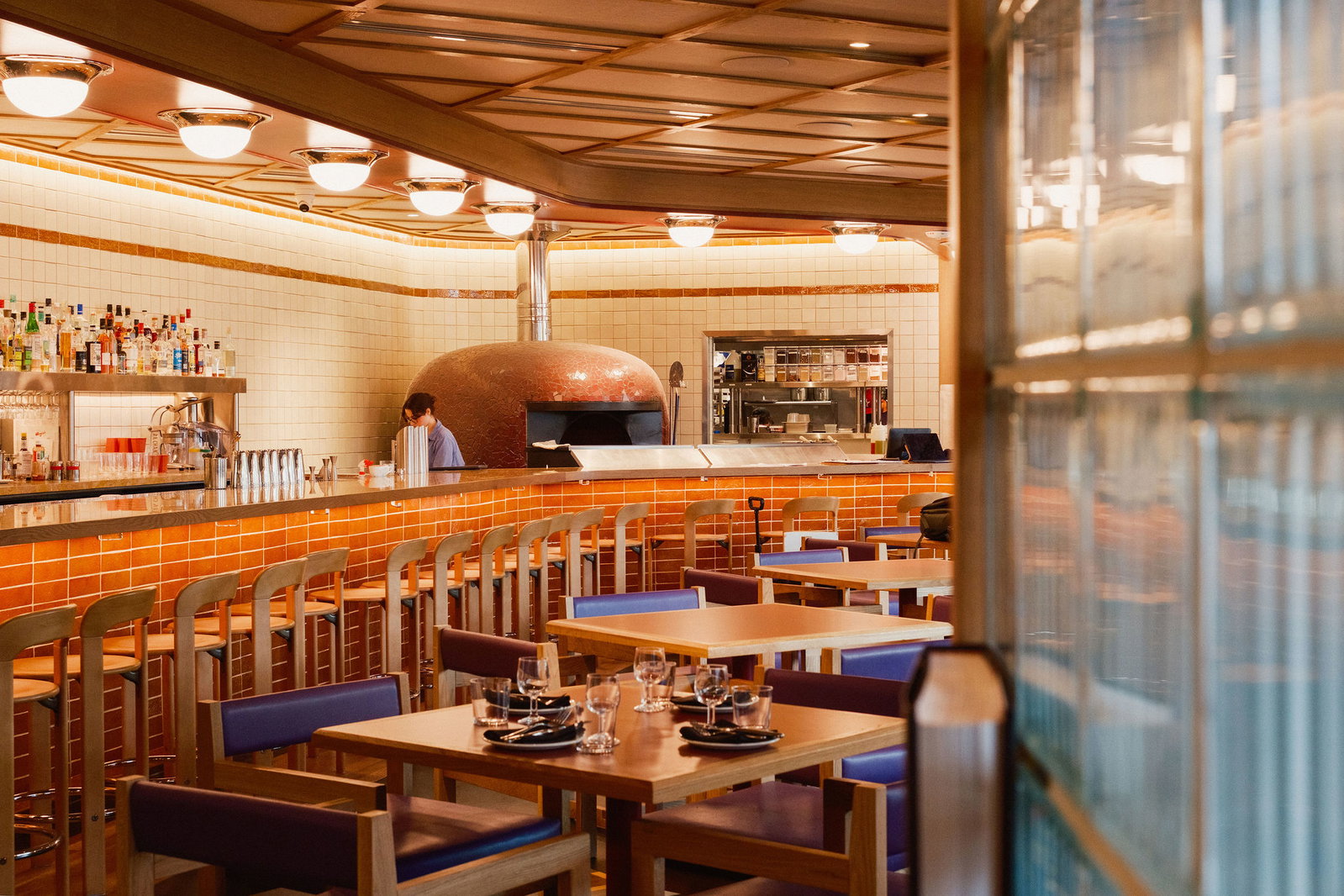 Housed in a circa 1950s two-story brick building in The Heights, transformed by Michael Hsu Office of Architecture and Gin Design, Angie's Pizza's interiors play up mid-century structure’s bones with classic furnishings from Mies van der Rohe chairs to a Saarinen table. (Photo by Chris Quit Nguyen)