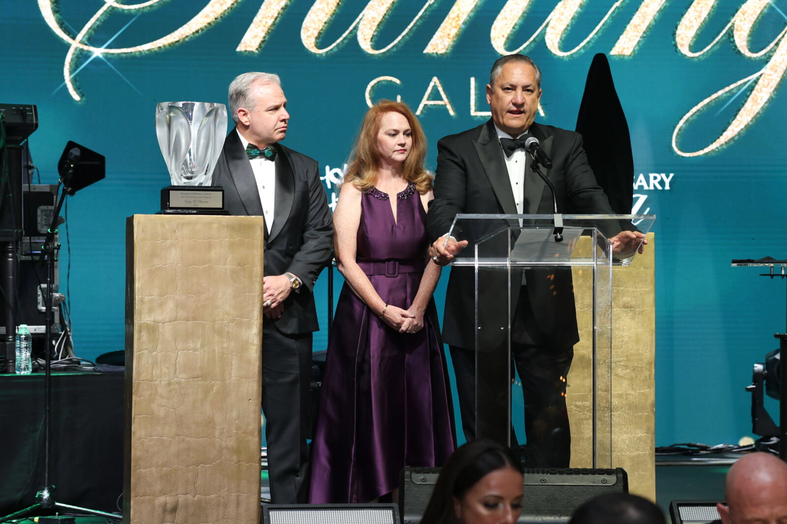 Randy Hopper, Katie & Mike Lowenberg unveil the Dave Ward Tribute Van at Houston Children's Charity gala (Photo by Priscilla Dickson)