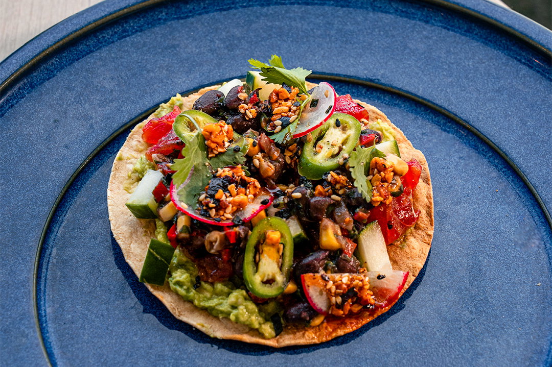 Do try some of our favorite starters, like the crisp tuna tostada ($18, shown) built upon a purée of avocado with black bean salsa and a shake of furikake seasoning, or the red shrimp cocktail ($25) with smoked cocktail sauce and an aioli spiked with the heat of Old Bay seasoning. Photo courtesy of Atrium Agency. (Photo by Rebekah Flores)