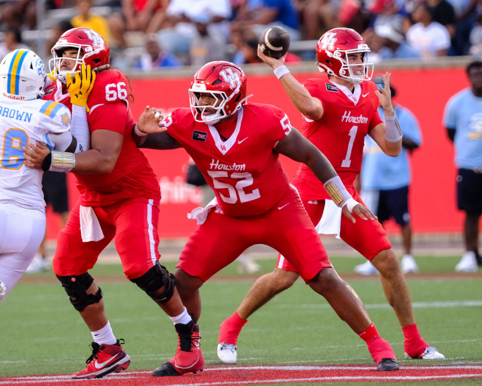 University of Houston center Anthony Boswell (No. 52) and right guard McKenzie Agnello (No. 66) keep Conner Weigman upright and let this UH offense roar. (Photo by F. Carter Smith)